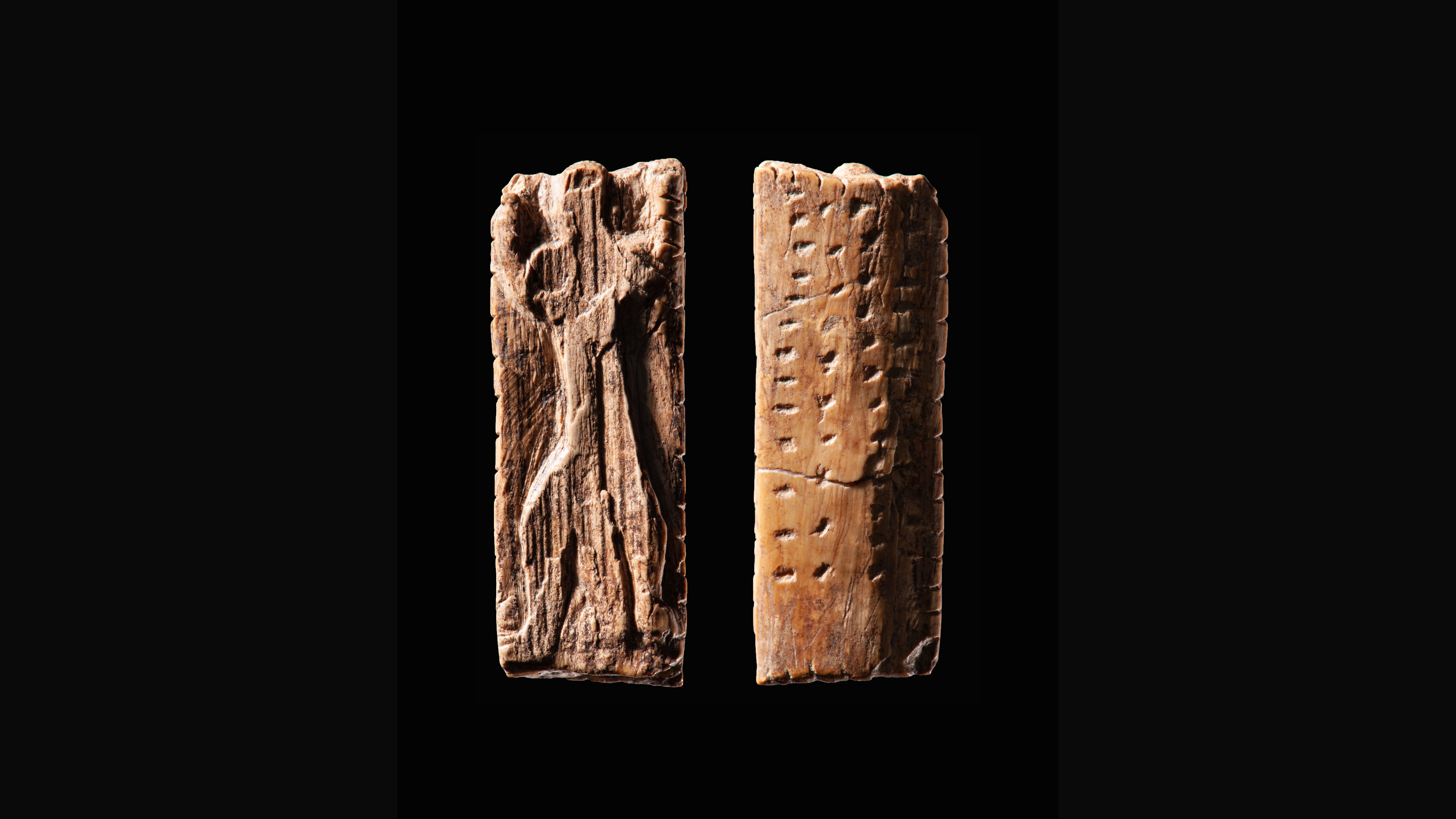 The Adorant ivory plaquette from Geißenklösterle Cave, approximately 40,000 years old – front side showing an anthropomorphic figure and back side showing rows of engraved notches and dots