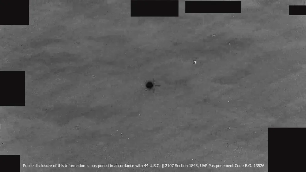 Official DVIDS still from DOW-UAP-PR143 Yellow Sea 2023 infrared – dark spherical object in clouds