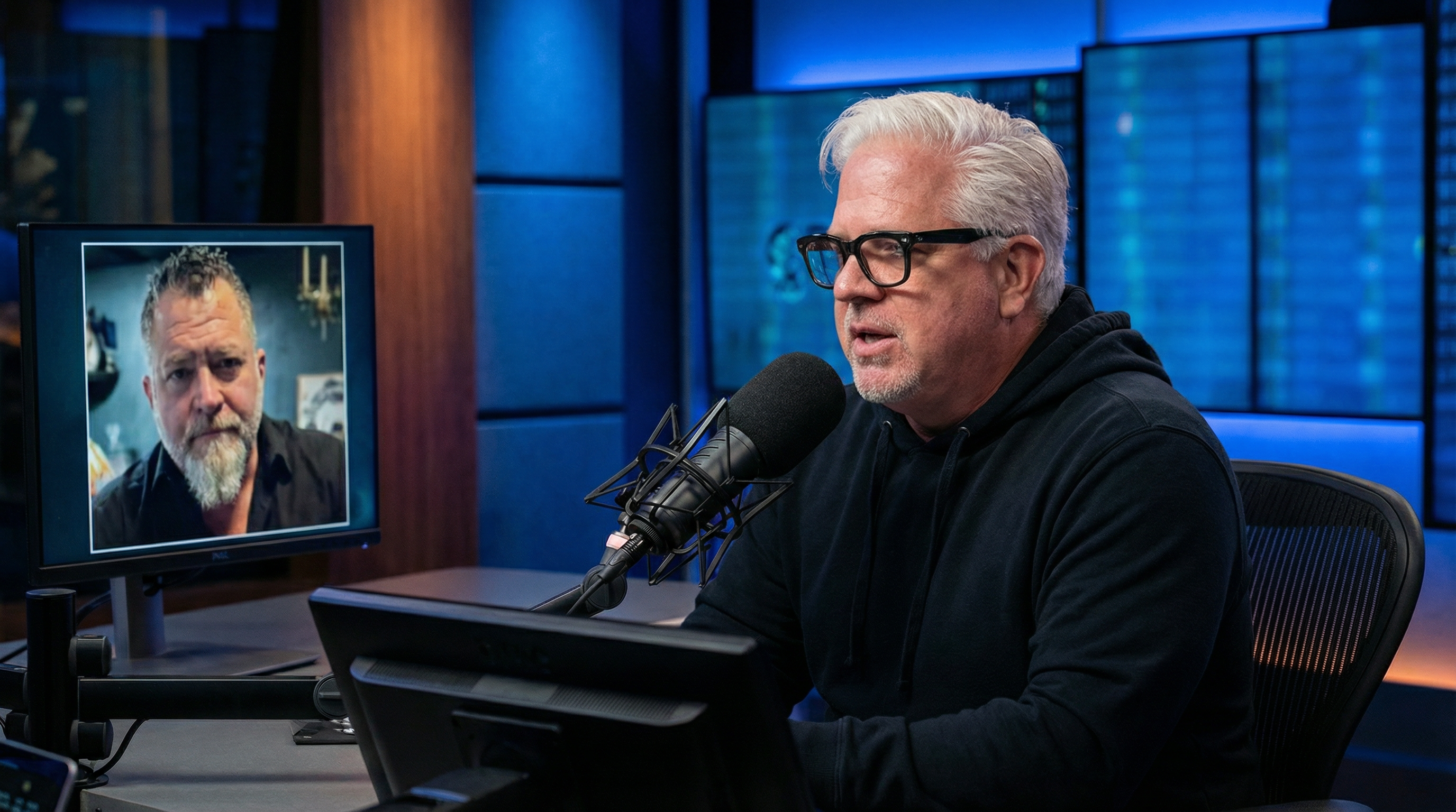 Glenn Beck at his broadcast desk with Luis Elizondo on screen via phone during their February 2026 UAP interview