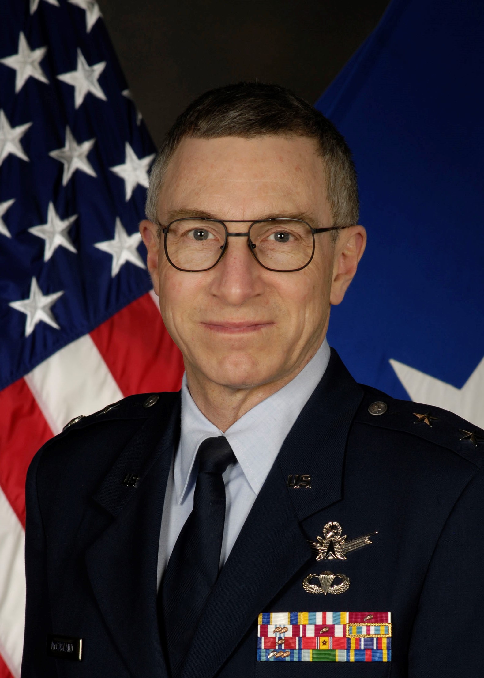 Retired USAF Maj. Gen. William McCasland in uniform with Kirtland Air Force Base in the background