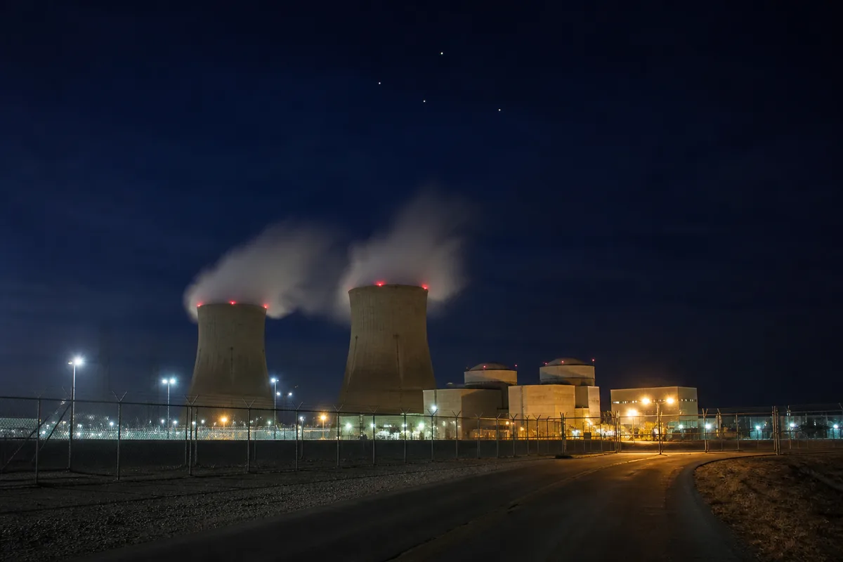 U.S. commercial nuclear plant at night with unidentified lights above the cooling towers